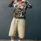 Street style zipup shirt with woodland pattern worn outside with grey background